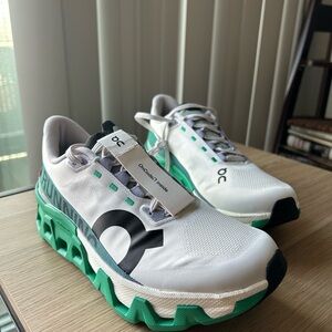 On Running White and Green Athletic Shoes